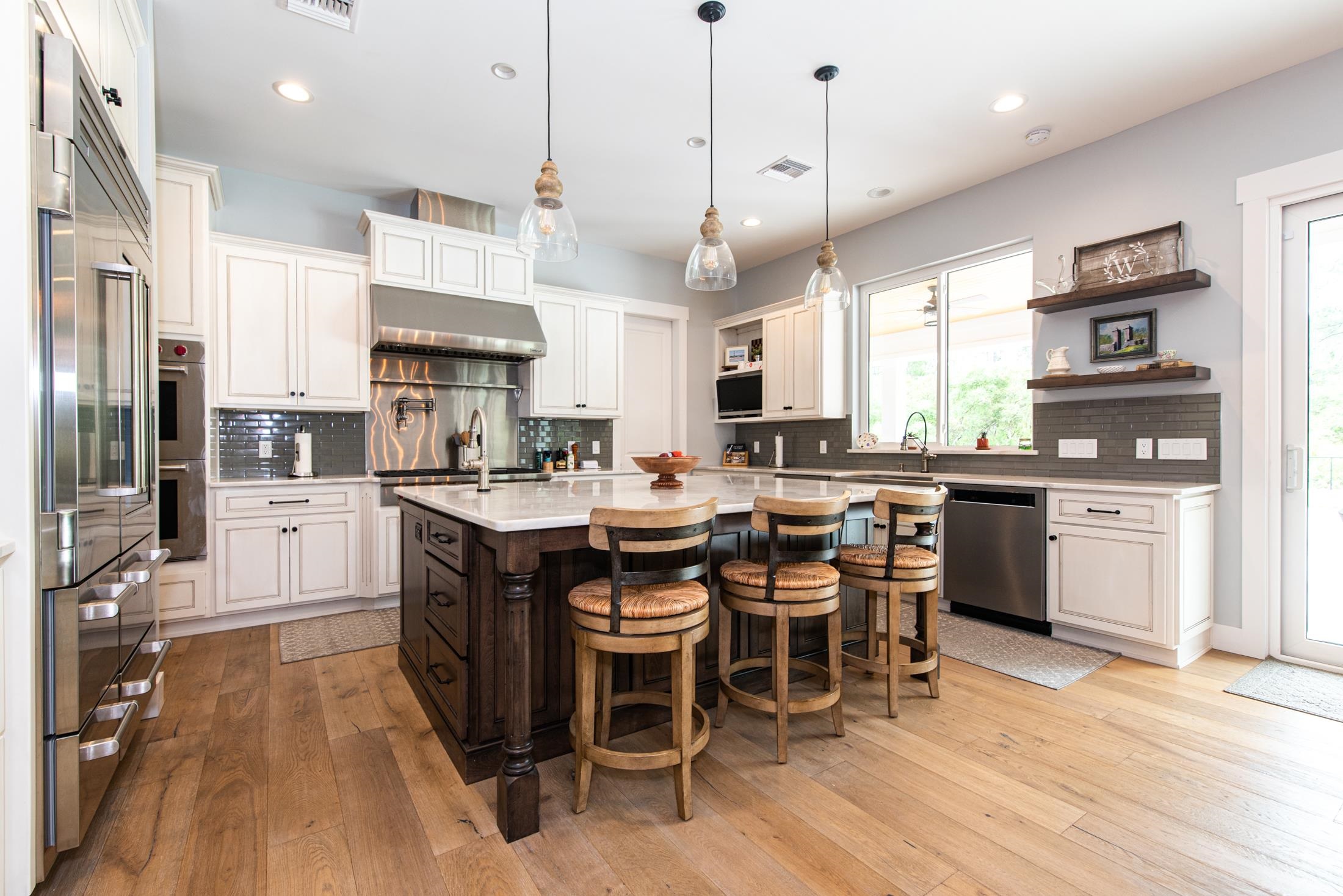 1015 Poinsettia Road St. Augustine, FL 32086 - Photo 4 of 50 a kitchen with stainless steel appliances kitchen island granite countertop a table chairs and a refrigerator