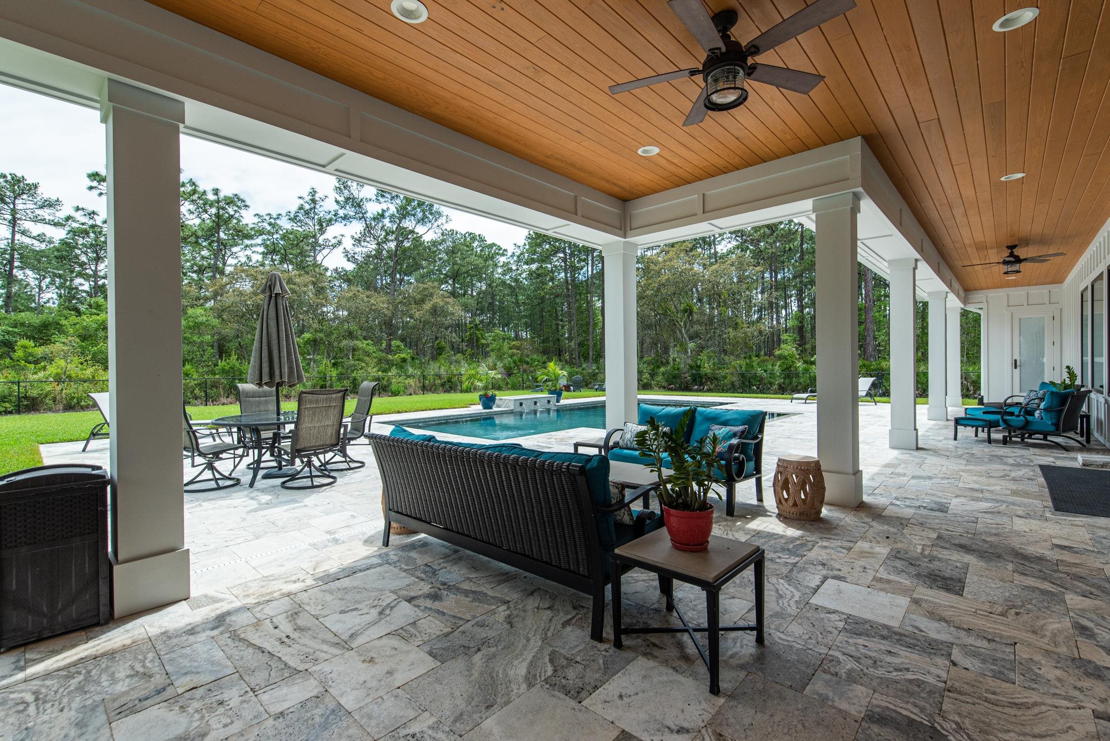 1015 Poinsettia Road St. Augustine, FL 32086 - Photo 46 of 50 a view of a patio with chairs and floor to ceiling window