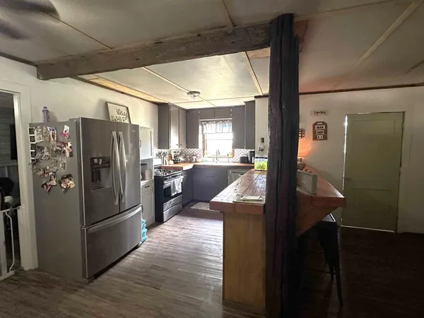 a kitchen with stainless steel appliances granite countertop a refrigerator and a sink