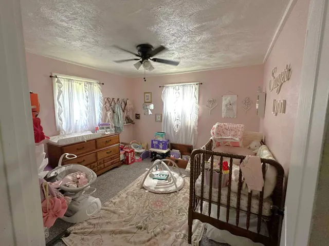 a living room with furniture fireplace and a window