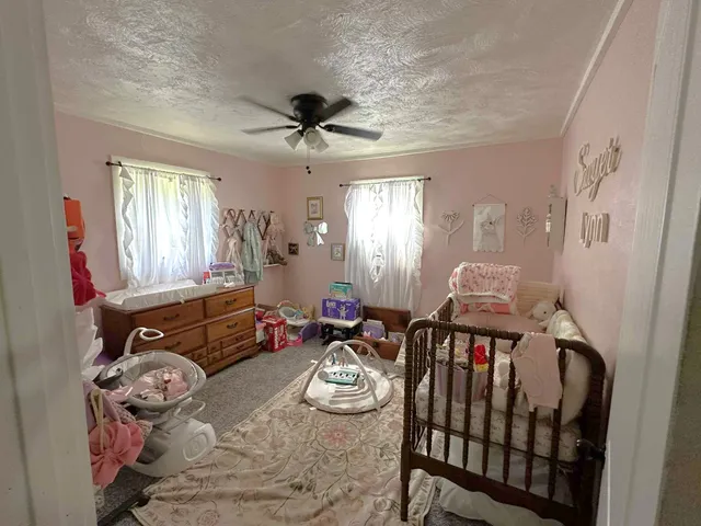 a living room with furniture fireplace and a window