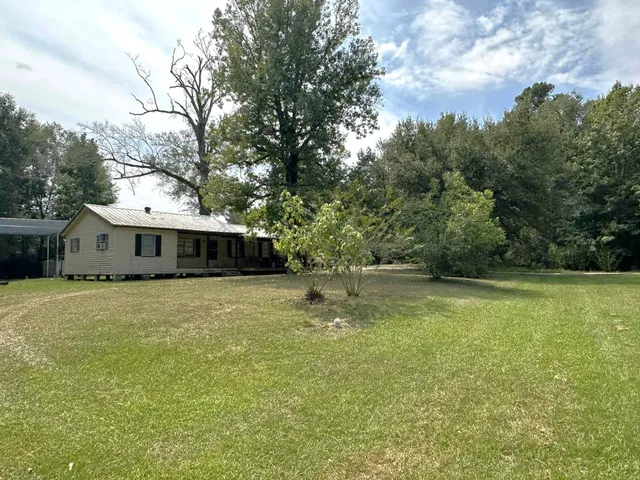 a swimming pool with trees in the background