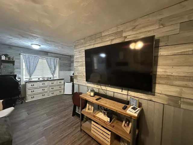 a room with furniture and flat screen tv