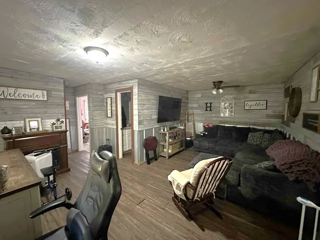 a living room with furniture and wooden floor