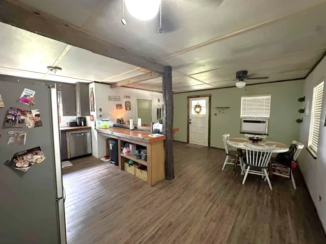a kitchen with a table chairs and a refrigerator