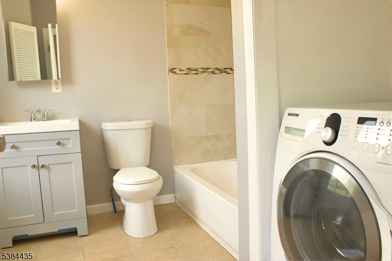 104 South 12th Street, Unit 3 Newark, NJ 07107 - Photo 3 of 12 a white toilet sitting next to a bathroom sink