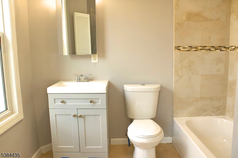 104 South 12th Street, Unit 3 Newark, NJ 07107 - Photo 4 of 12 a bathroom with a sink toilet and shower