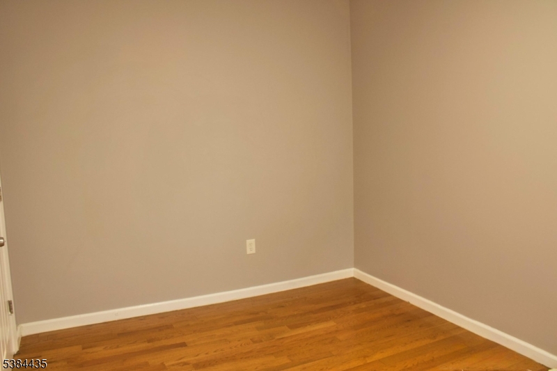 104 South 12th Street, Unit 3 Newark, NJ 07107 - Photo 6 of 12 a view of an empty room with wooden floor