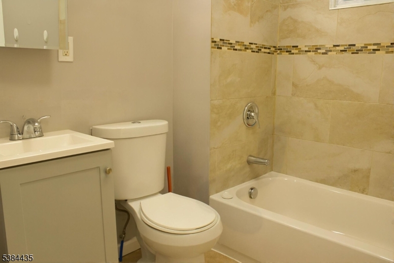 104 South 12th Street, Unit 3 Newark, NJ 07107 - Photo 10 of 12 a bathroom with a sink a toilet and shower