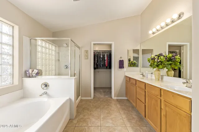 a spacious bathroom with a bathtub sink and mirror