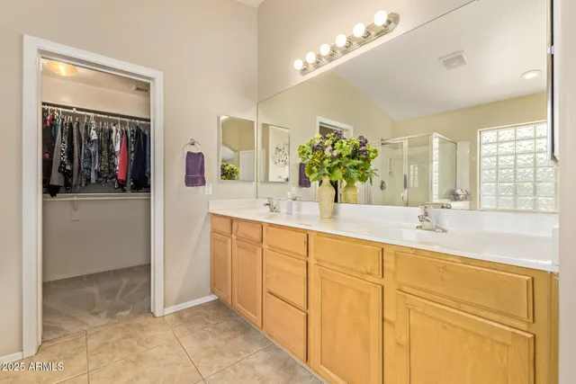 a bathroom with a sink vanity and mirror
