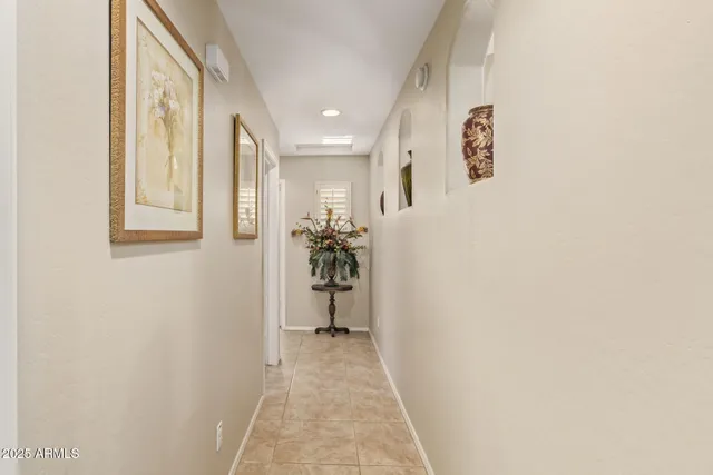 a view of a hallway with paintings on the wall