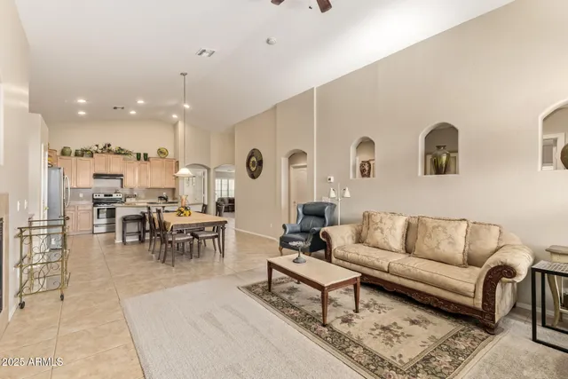 a living room with lots of furniture and kitchen view