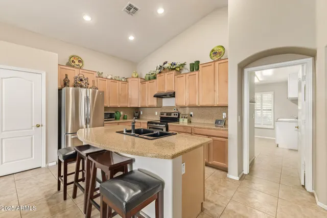 a kitchen with a refrigerator a stove and a sink