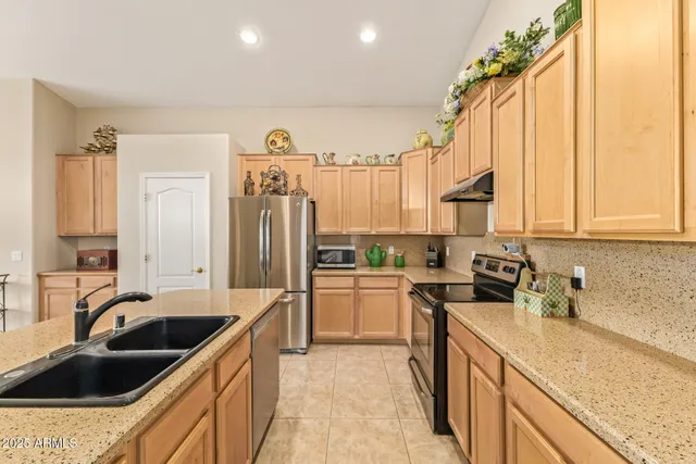 a kitchen with a sink stove and refrigerator