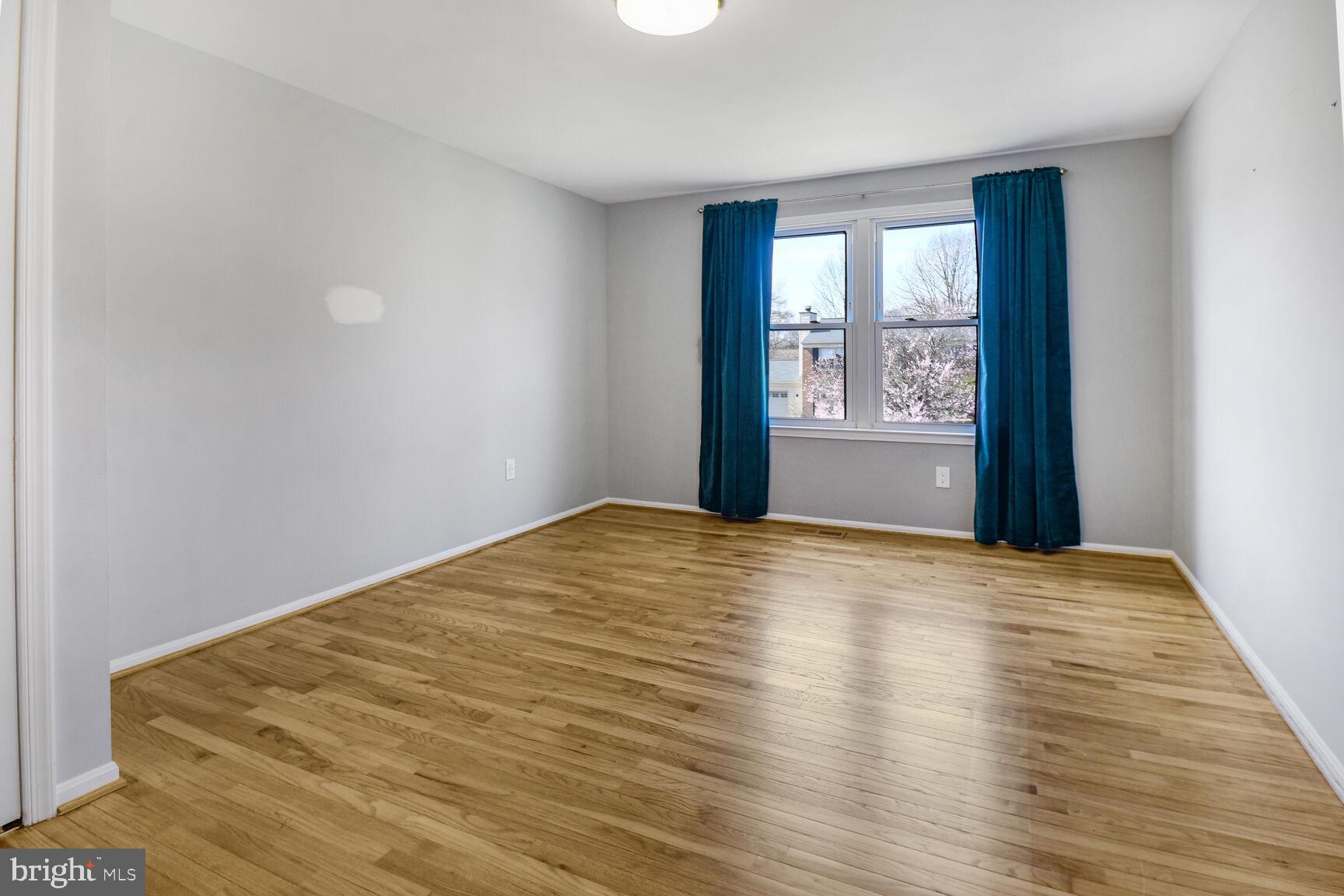 15320 Baileys Lane Silver Spring, MD 20906 - Photo 11 of 28 a view of empty room with wooden floor and fan