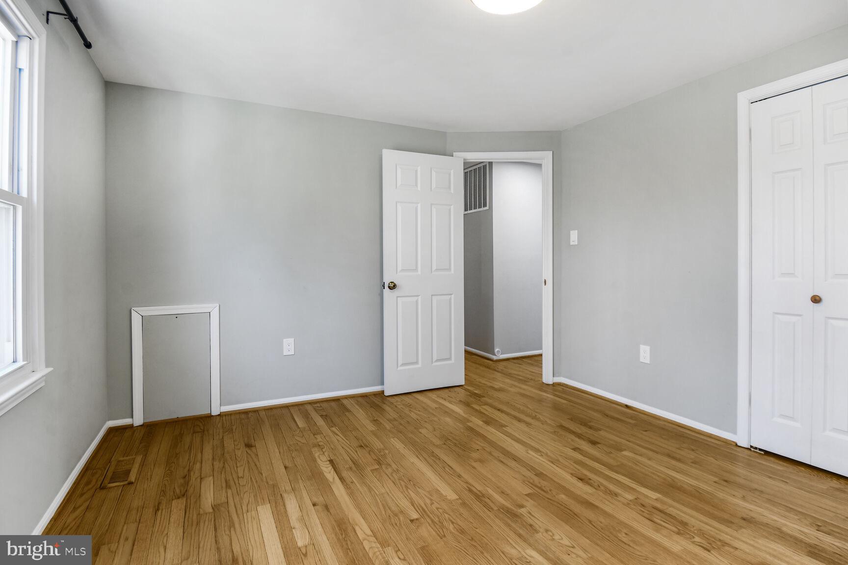 15320 Baileys Lane Silver Spring, MD 20906 - Photo 14 of 28 an empty room with wooden floor and windows