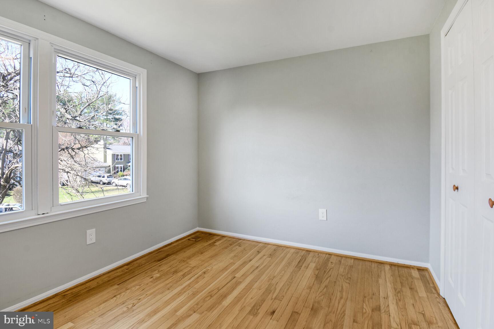 15320 Baileys Lane Silver Spring, MD 20906 - Photo 15 of 28 an empty room with wooden floor and windows