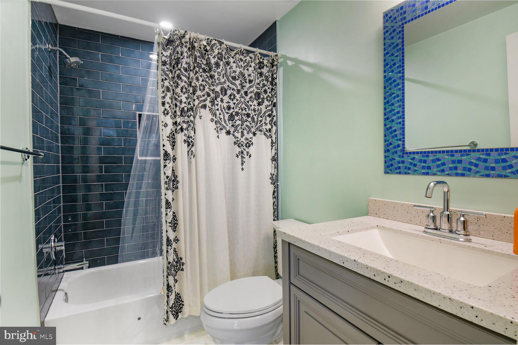 15320 Baileys Lane Silver Spring, MD 20906 - Photo 19 of 28 a bathroom with a granite countertop toilet a sink and a bathtub