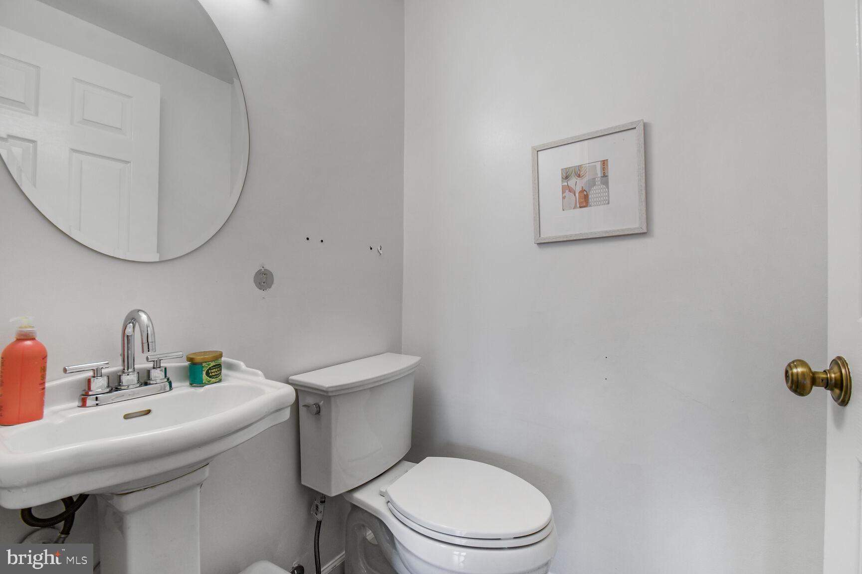 15320 Baileys Lane Silver Spring, MD 20906 - Photo 20 of 28 a white toilet sitting next to a bathroom sink
