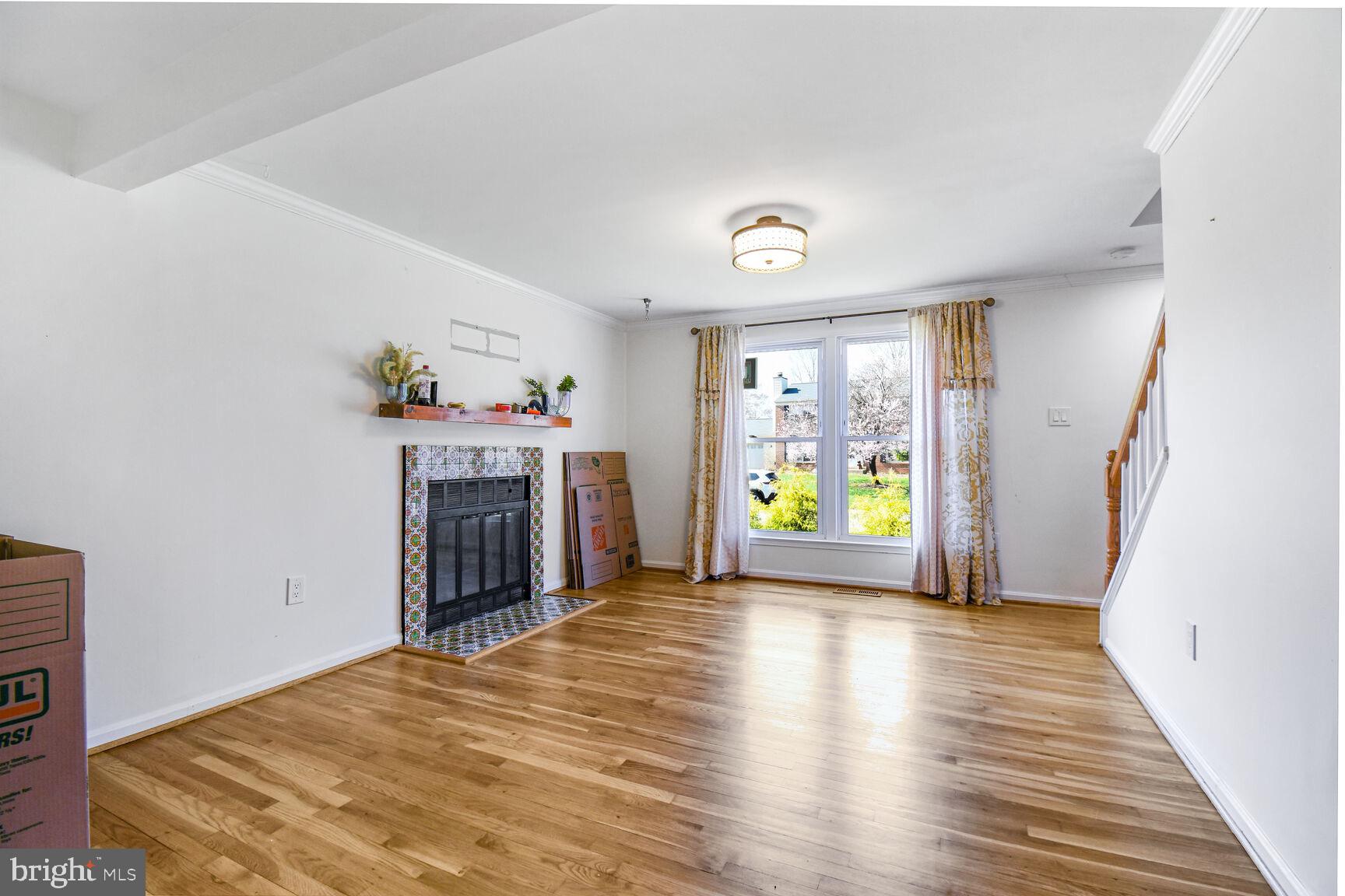 15320 Baileys Lane Silver Spring, MD 20906 - Photo 3 of 28 a view of an empty room with a fireplace and a window