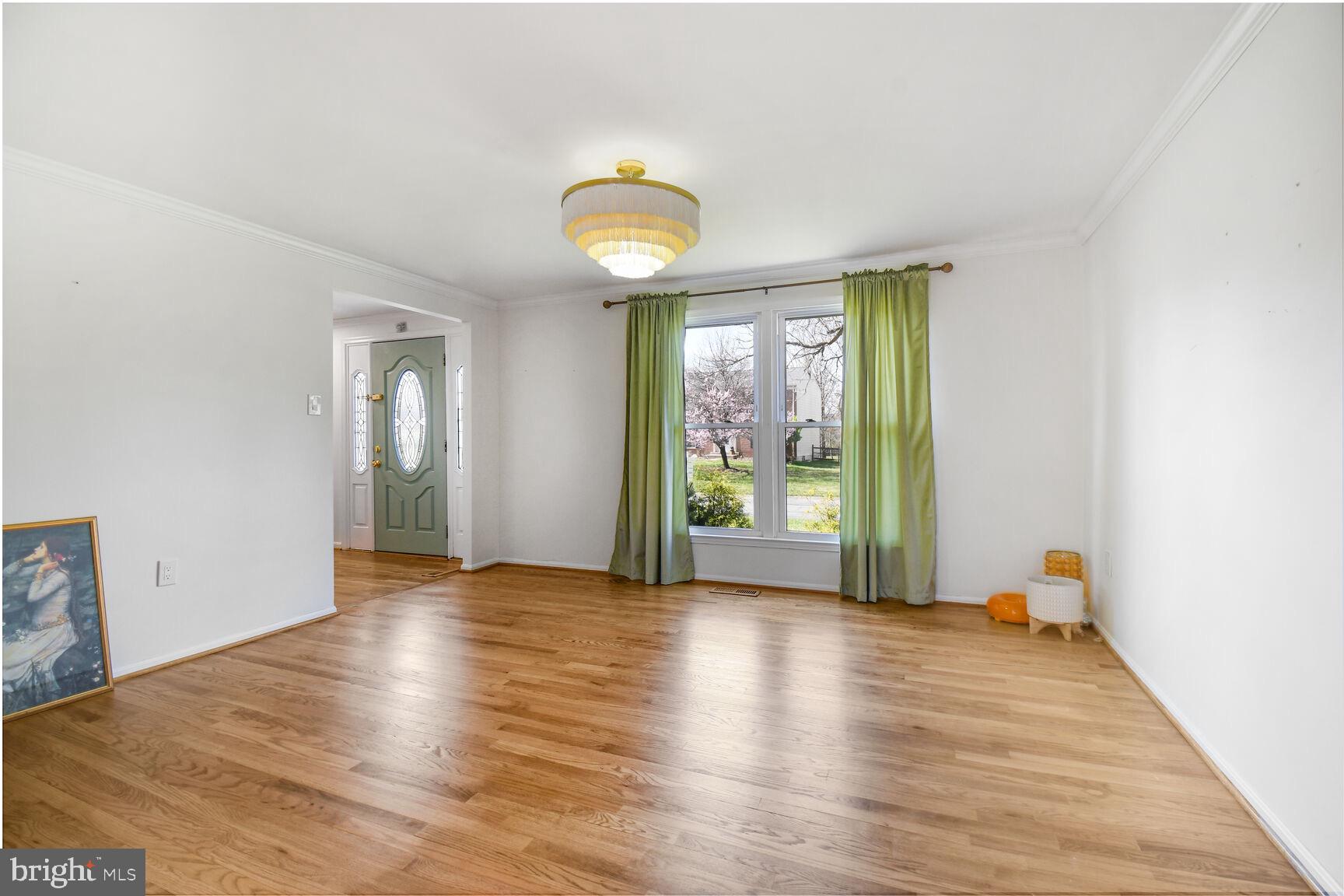 15320 Baileys Lane Silver Spring, MD 20906 - Photo 5 of 28 a view of an empty room with wooden floor and a window