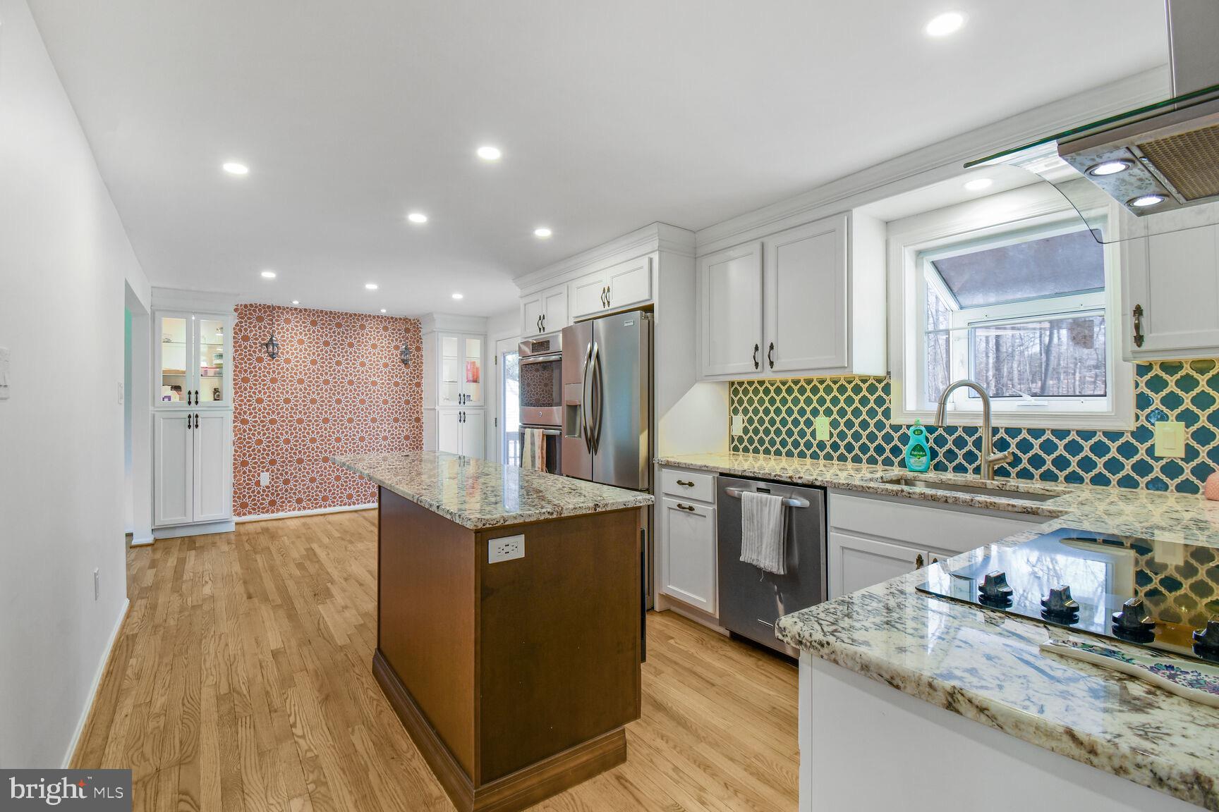 15320 Baileys Lane Silver Spring, MD 20906 - Photo 7 of 28 a kitchen with stainless steel appliances granite countertop a sink stove and refrigerator