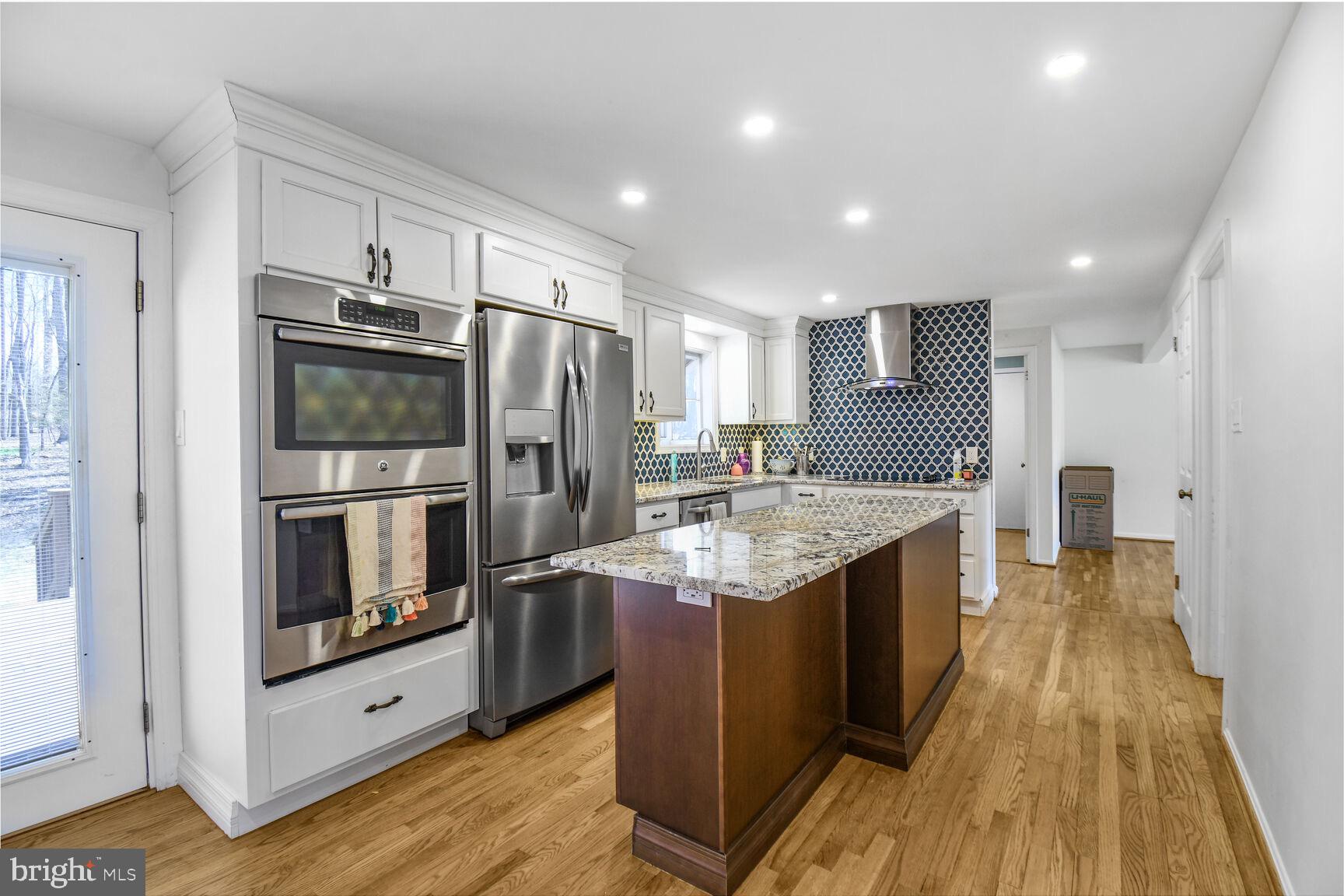 15320 Baileys Lane Silver Spring, MD 20906 - Photo 8 of 28 a kitchen with stainless steel appliances granite countertop a refrigerator and a sink