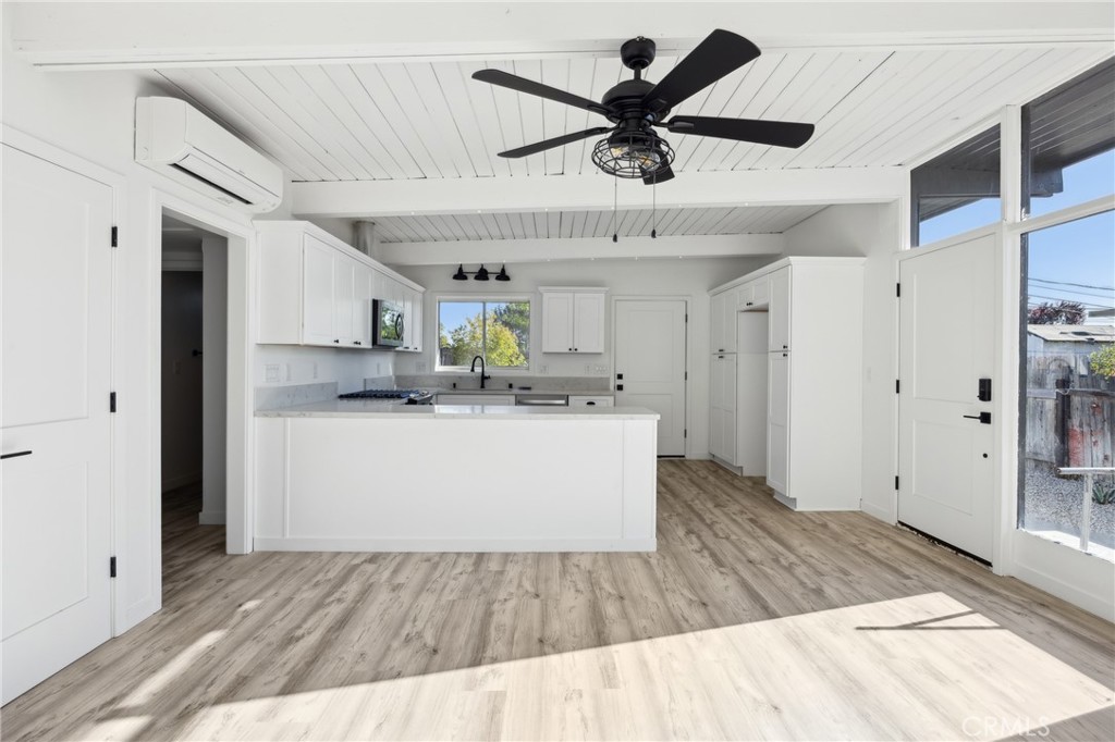 528 Creston Road Paso Robles, CA 93446 - Photo 22 of 46 a view of kitchen with stainless steel appliances granite countertop a refrigerator a sink dishwasher and white cabinets with wooden floor
