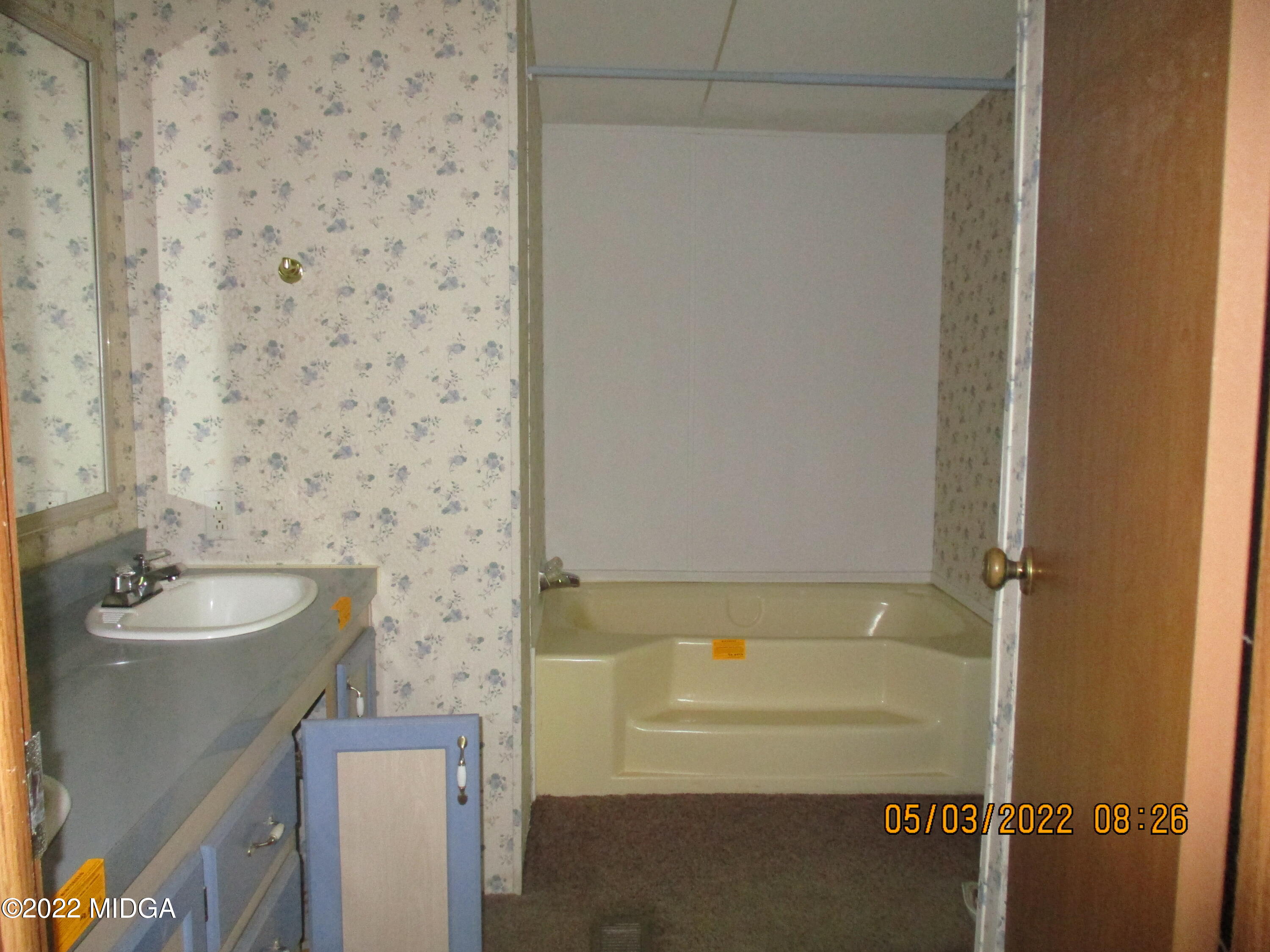 576 Hendrick Road Fort Valley, GA 31030 - Photo 15 of 19 a bathroom with a granite countertop sink and a bathtub