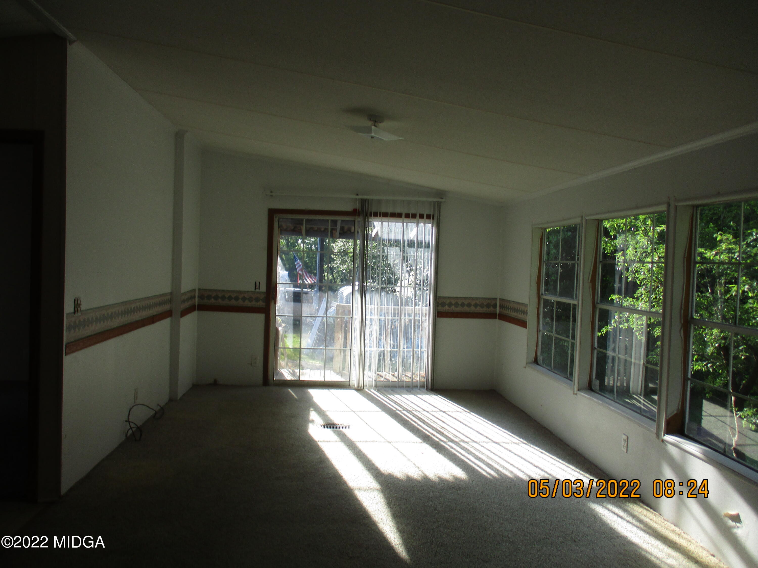 576 Hendrick Road Fort Valley, GA 31030 - Photo 7 of 19 a view of an empty room with wooden floor and a window