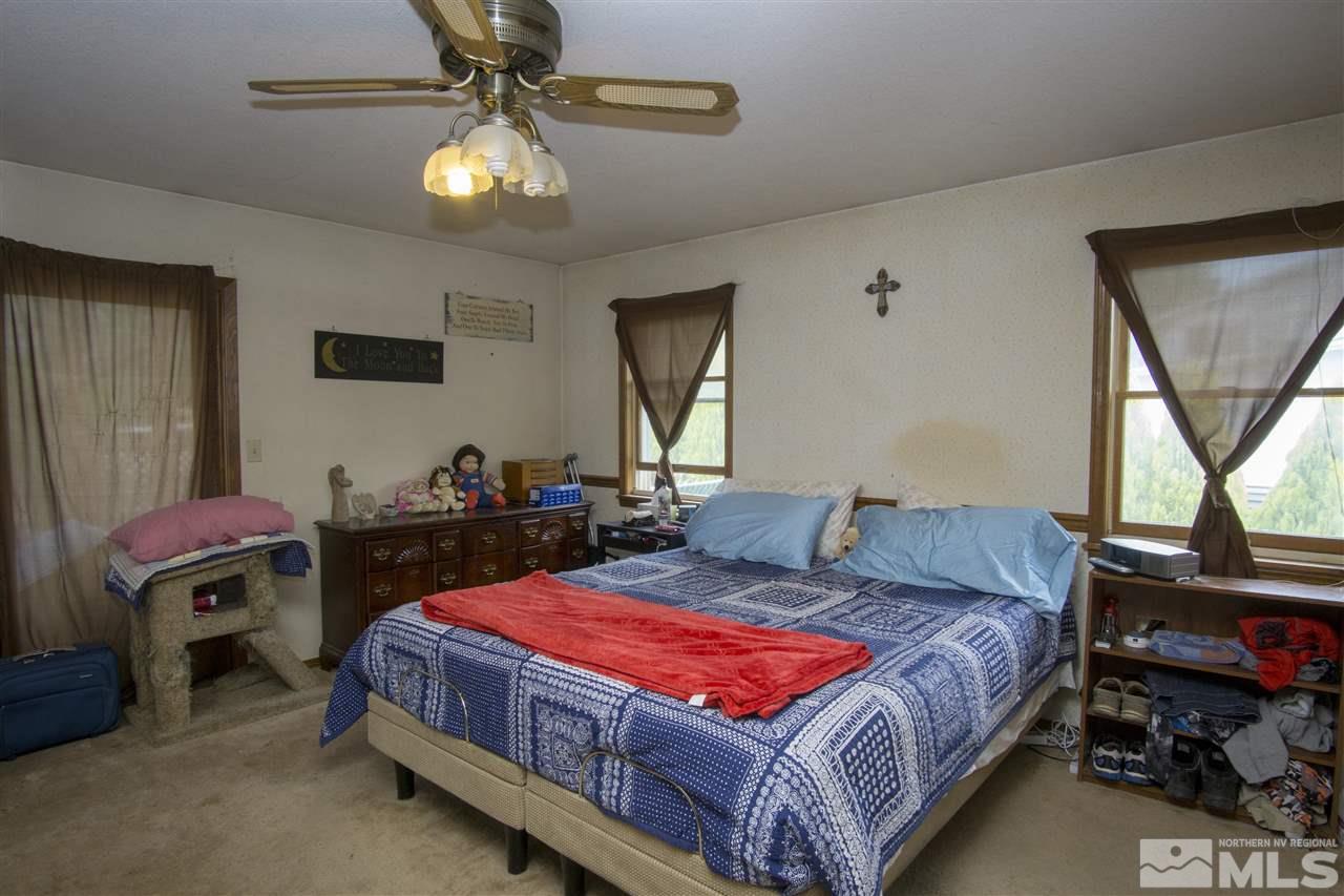 3106 Bottom Road Fallon, NV 89406 - Photo 8 of 16 a bedroom with a bed and a chandelier