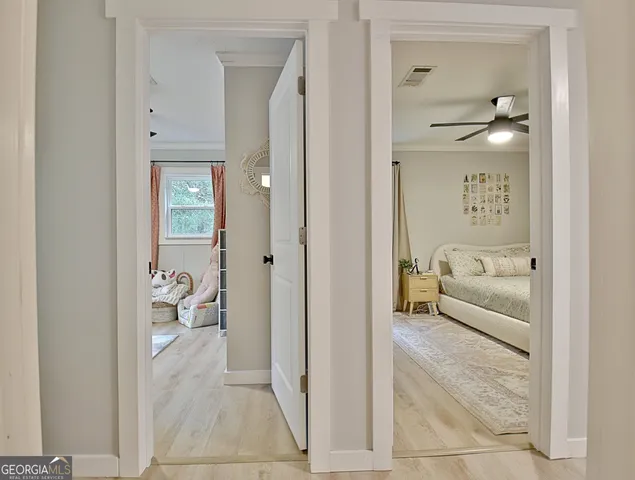 a bedroom with a bed and a flat tv screen on the dresser