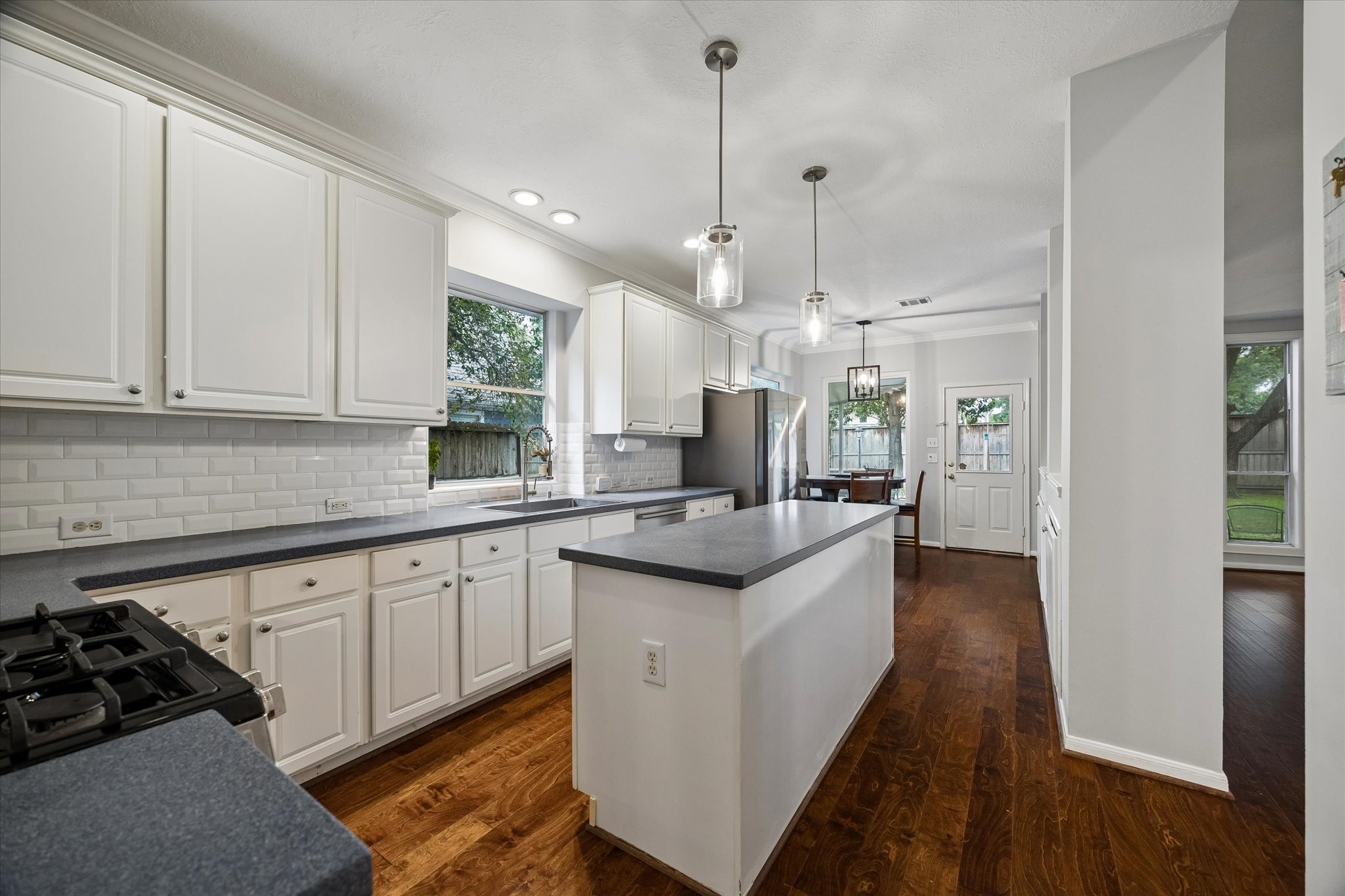 8123 Clarion Way Houston, TX 77040 - Photo 13 of 33 a kitchen with stainless steel appliances granite countertop a sink a stove and a wooden floor