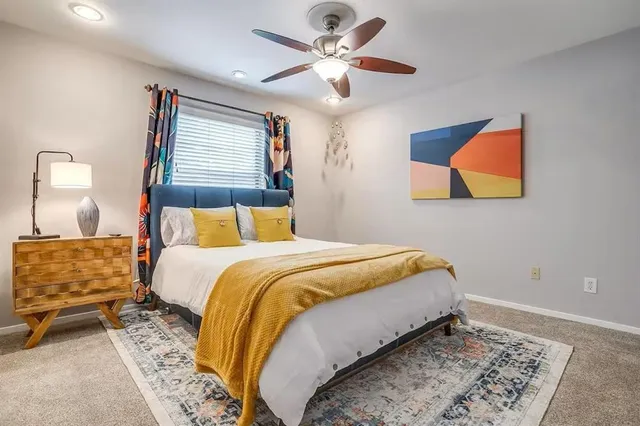 a spacious bathroom with a granite countertop sink mirror and vanity