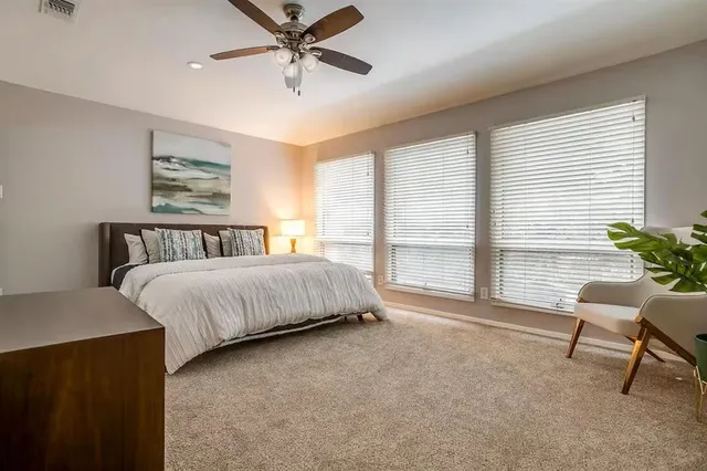 a bathroom with a granite countertop sink mirror and toilet