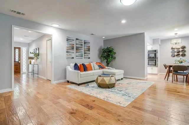 a living room with furniture and a potted plant