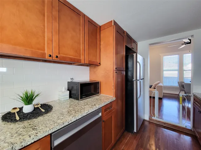 a kitchen with stainless steel appliances granite countertop a sink stove and cabinets