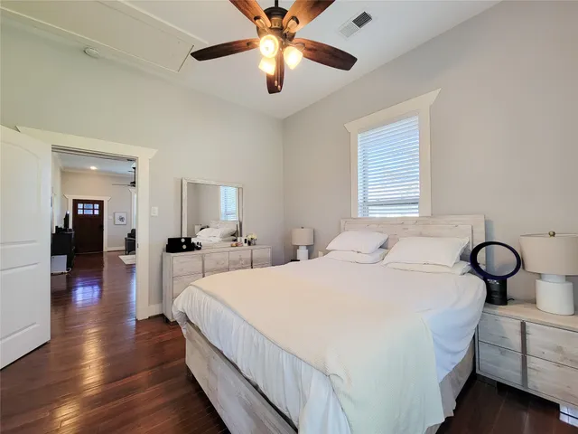 a bedroom with a large bed and a window