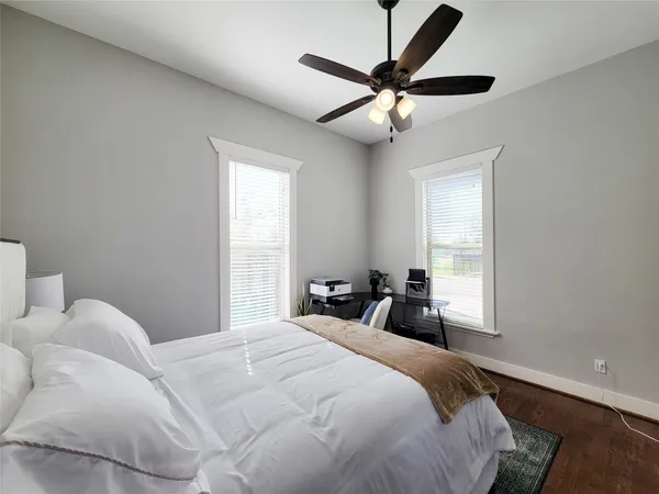 a bedroom with a large bed and a window