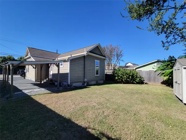a front view of house with yard and trees in the background