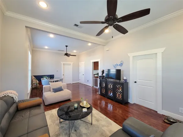 a living room with furniture and a wooden floor