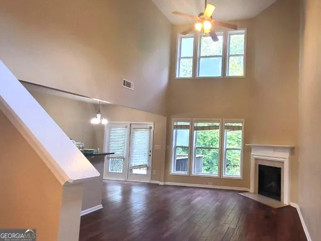 a view of an entryway with wooden floor and door
