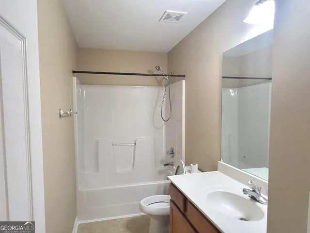 a bathroom with a tub a sink and mirror