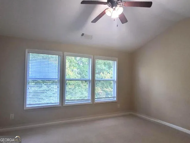 a balcony with wooden floor and fence