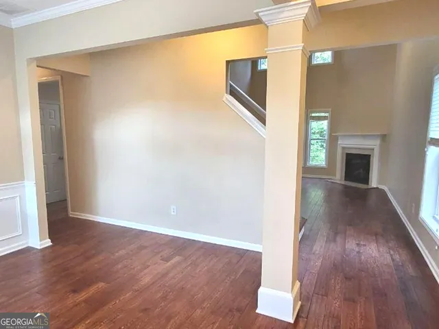 a view of a livingroom with a window and wooden floor