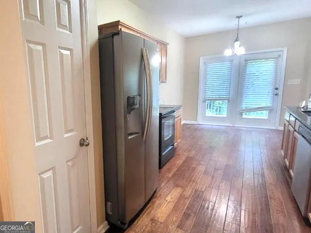 a view of an empty room with a fireplace and a window