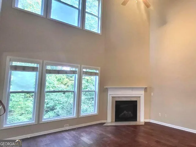 a living room with a fireplace and a floor to ceiling window
