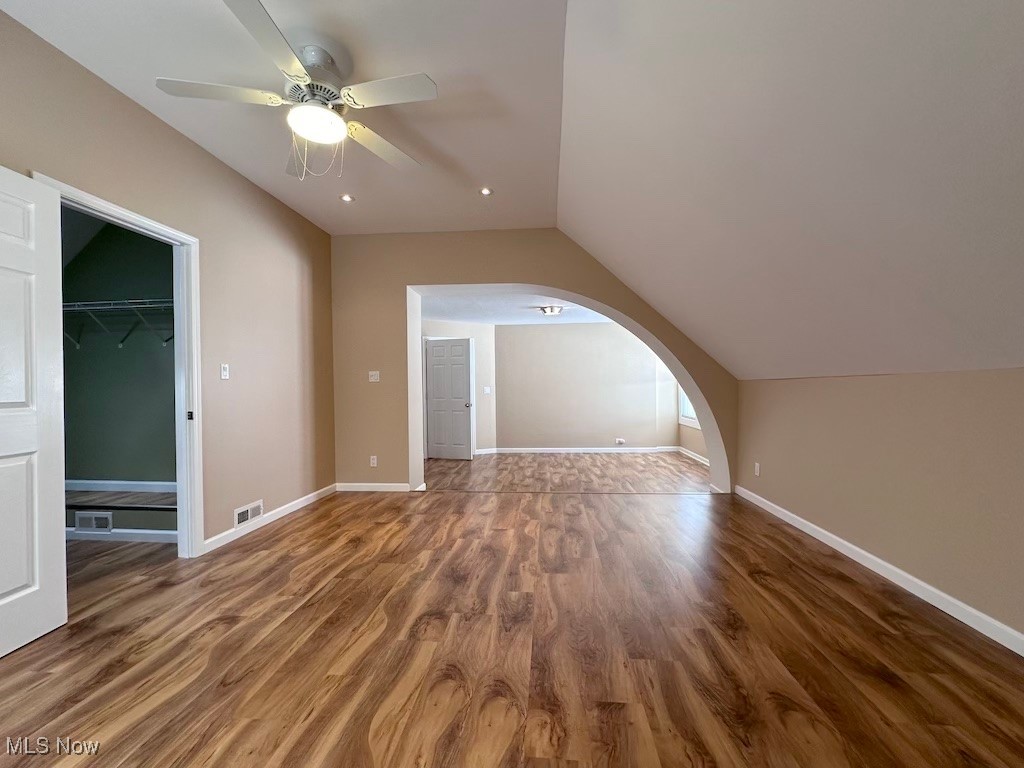 6846 Ottawa Road Cleveland, OH 44105 - Photo 29 of 50 Additional living space featuring lofted ceiling, wood finished floors, arched walkways, and visible vents