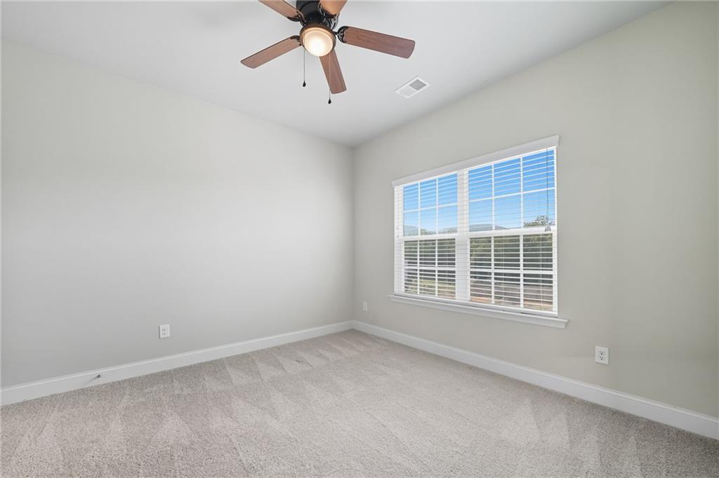 33 North Village Circle Rydal, GA 30171 - Photo 18 of 48 an empty room with a window and a fan